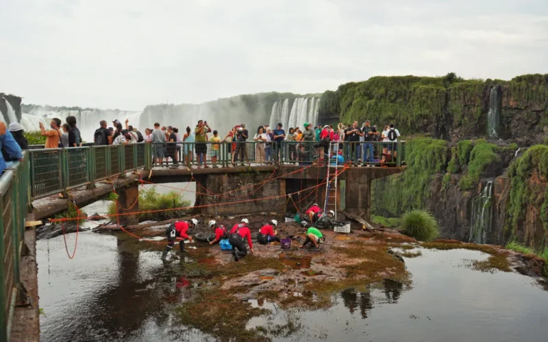 Funcionários da Urbia Cataratas recolhendo moedas do Rio Iguaçu