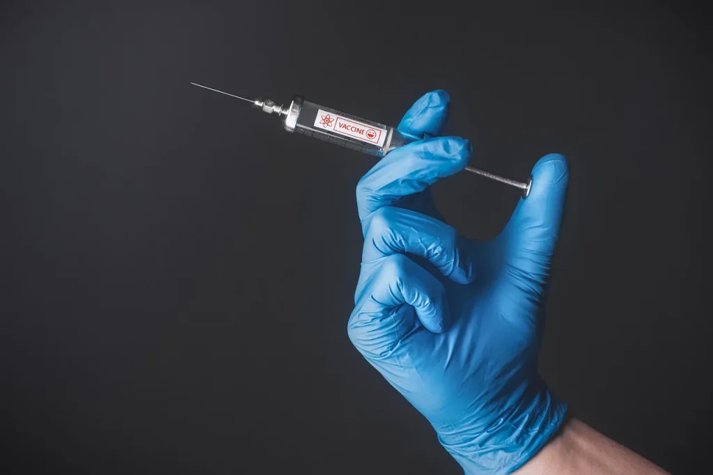 Frasco de vacina contra dengue em ambiente clínico com luvas e seringa